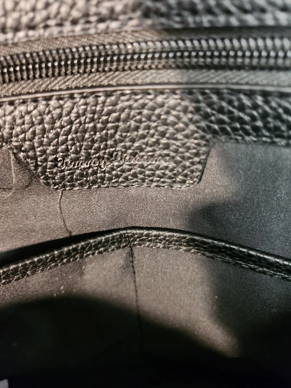 Tommy Bahama black Nylon and leather Weekender Bag featuring a trolley sleeve.